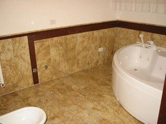 Bathroom with matching granite and marble covering and flooring