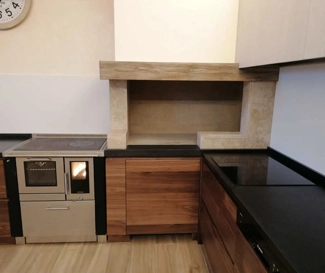 Black Granite countertop and marble wall covering of fireplace