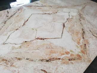 Pre-installation of open-spot flooring in Breccia Aurora marble